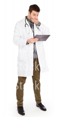 Male Caucasian doctor holding a digital tablet, looking shocked