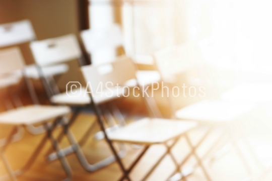 Classroom with empty chairs and warm bokeh background