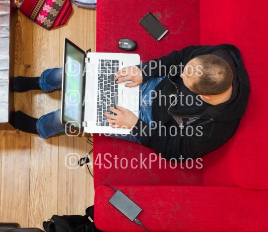 High angle view of a man using his laptop