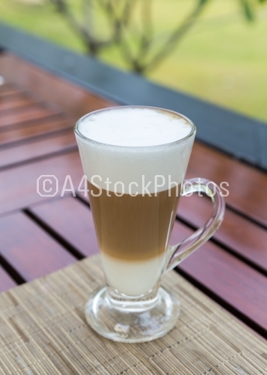 Latte macchiato in a glass with milk froth