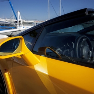 A yellow expensive supercar on the quay