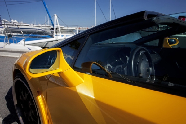 A yellow expensive supercar on the quay