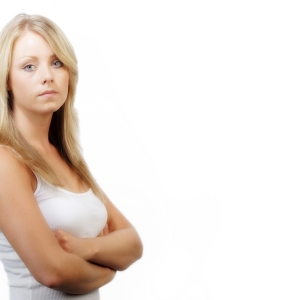 Pretty young girl looking at camera with arms folded