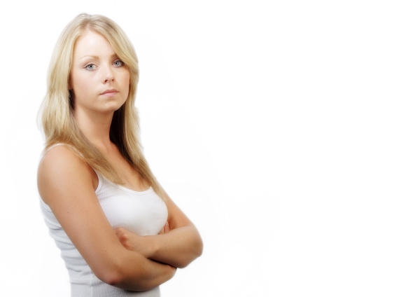 Pretty young girl looking at camera with arms folded