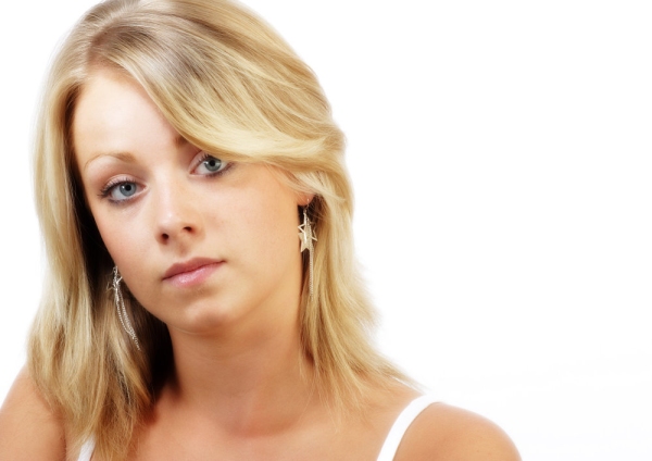 Pretty young blonde girl looking at camera in a wistful way