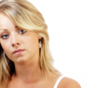 Pretty young blonde girl looking at camera in a wistful way