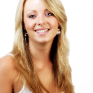 Pretty young blonde girl smiling at camera