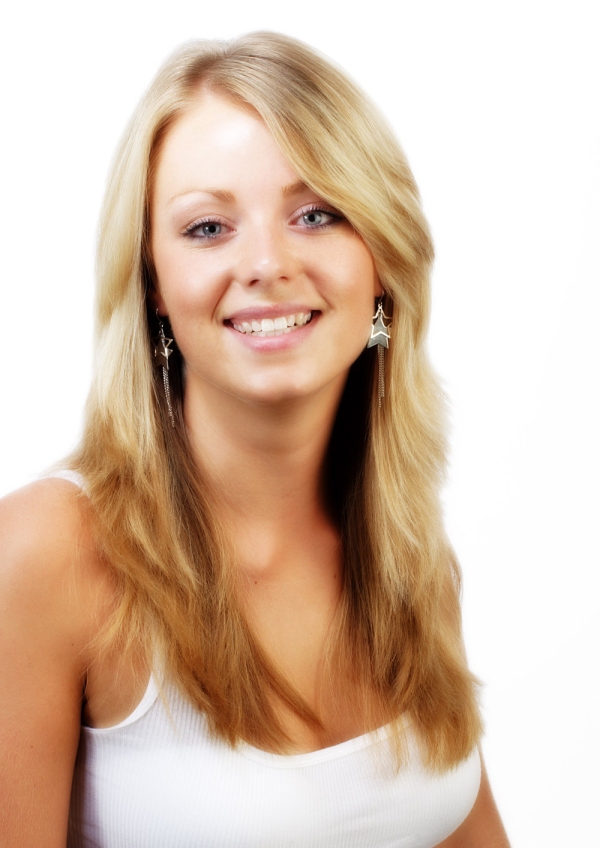 Pretty young blonde girl smiling at camera