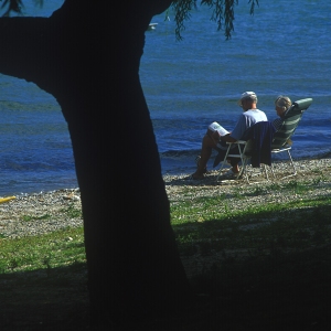 A middle aged couple relaxing on the shores of Lake Como in Italy