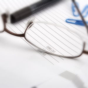 Macro view of business invoice and spectacles