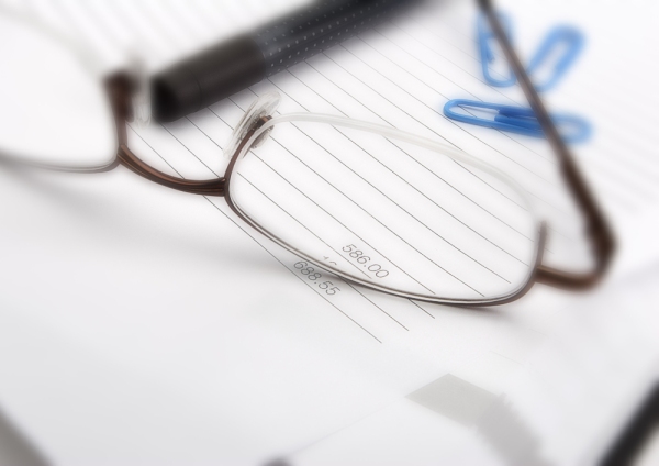 Macro view of business invoice and spectacles