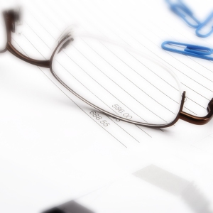 Macro view of business invoice and spectacles