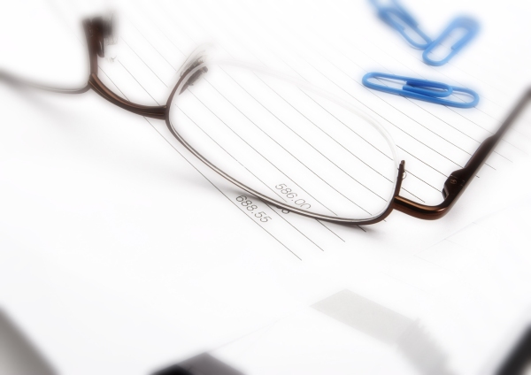 Macro view of business invoice and spectacles