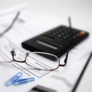 Macro view of invoice, glasses and calculator