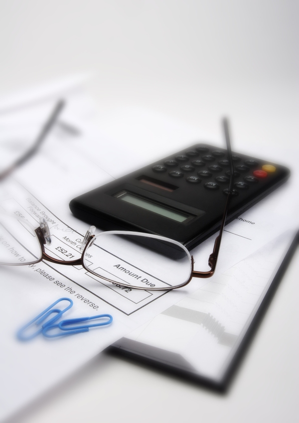 Macro view of invoice, glasses and calculator