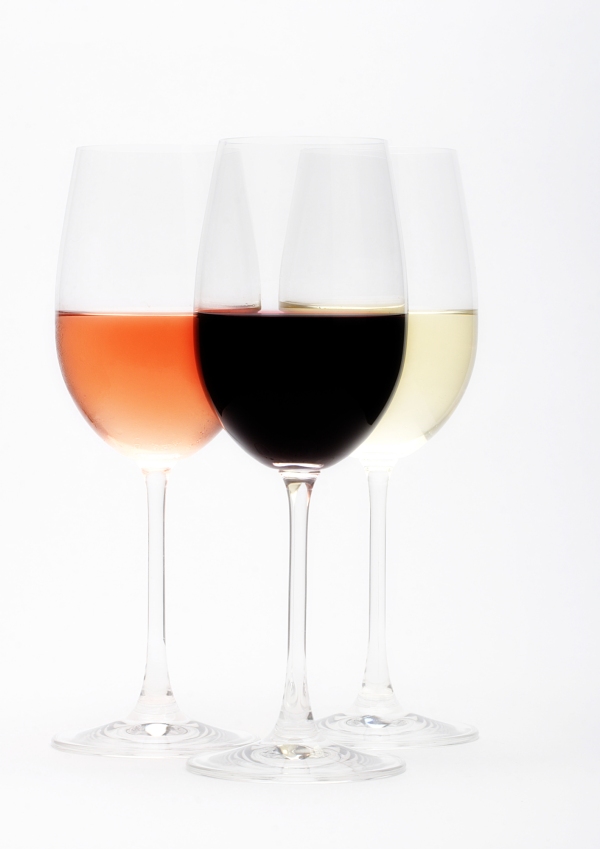 Three wine glasses containing, red, white and rosé wine