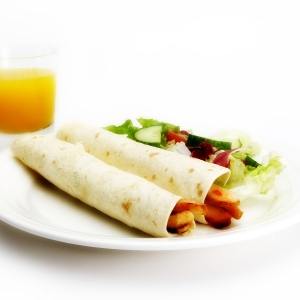 chicken wraps with a green salad and fresh orange juice