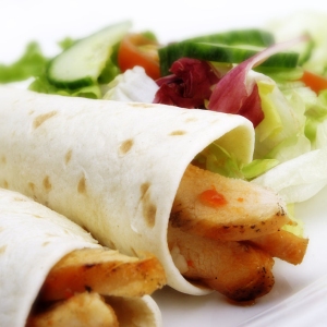 chicken wraps, pancake, salad, lettuce, cucumber, tomato, orange juice, salad, vegetables