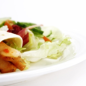 chicken wraps with a green salad and fresh orange juice