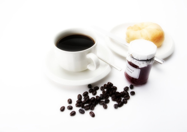 A cup of coffee with some arabica coffee beans, a doughnut & jam