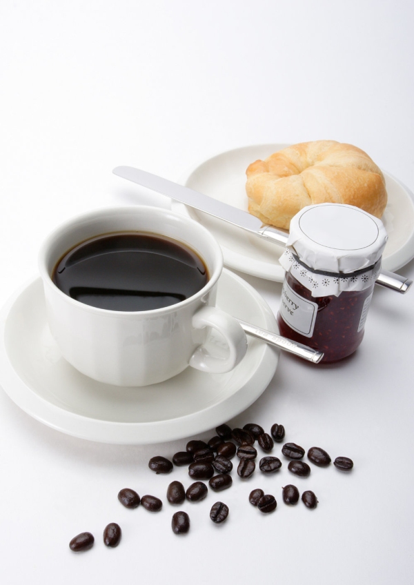 A cup of coffee with some arabica coffee beans, jam and doughnut