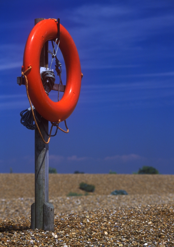 A lifebelt station on a shingle beach close to the sea