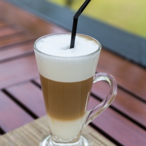 Latte macchiato in a glass with milk froth.