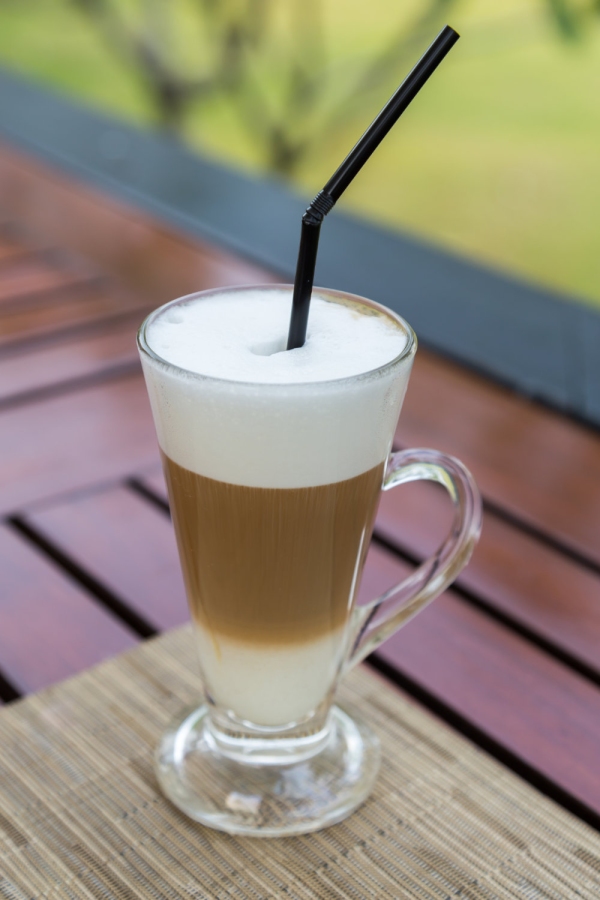 Latte macchiato in a glass with milk froth.