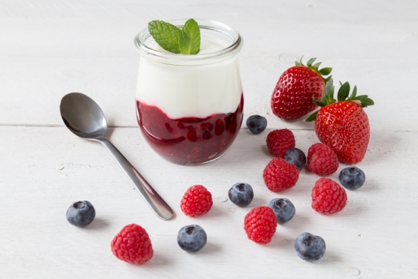 Red fruit compote with mint leaves and fruit.