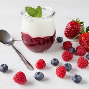 Red fruit compote with mint leaves and fruit.