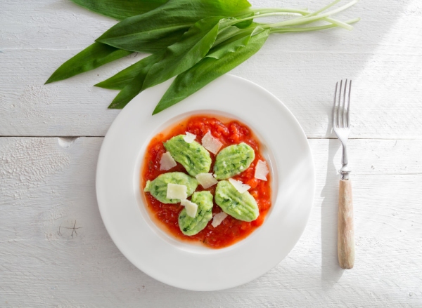 Gnocchi with wild garlic in tomato sauce and parmesan cheese.