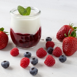 Red fruit compote with mint leaves and fruit.