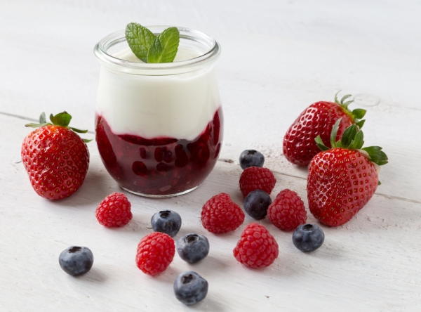 Red fruit compote with mint leaves and fruit.