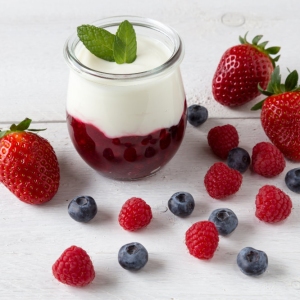 Red fruit compote with mint leaves and fruit.