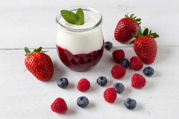 Red fruit compote with mint leaves and fruit.