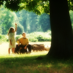 Young boy and girl playing in the forest