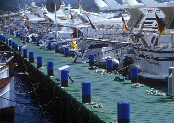 A jetty at the marina, with luxury yachts at anchor