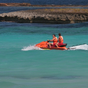 Two men on a speedboat in rough sea