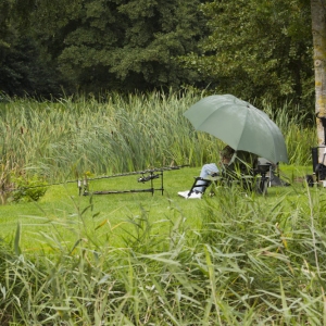 Carp fishing in the rain on a summer lake