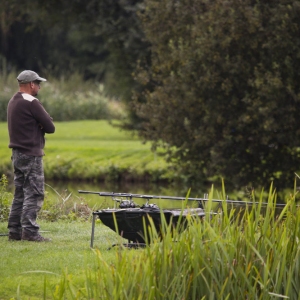 Carp fisherman or angler watching the lake