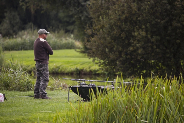 Carp fisherman or angler watching the lake