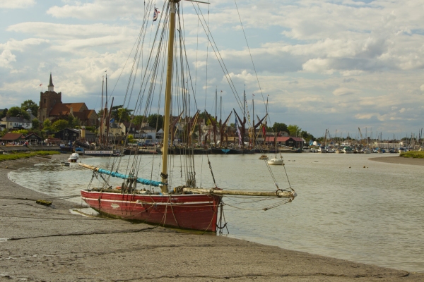 A sailing boat sitting on the mud at Maldon in Essex at low tide