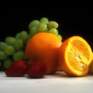 Close up of oranges grapes an strawberries