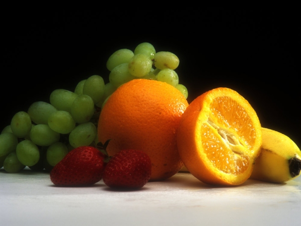 Close up of oranges grapes an strawberries