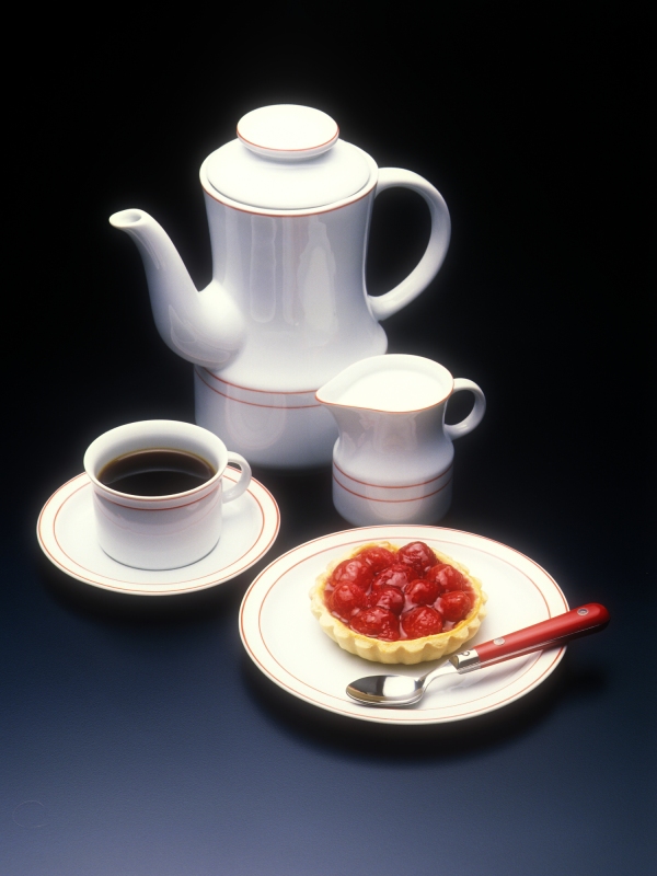 A coffee pot with milk jug and a fruit tart