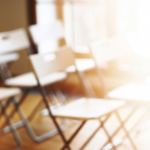 Classroom with empty chairs and warm soft focus background