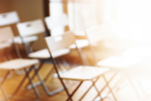 Classroom with empty chairs and warm soft focus background