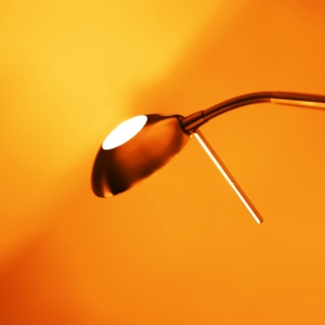 Orange tinted photo of desk lamp