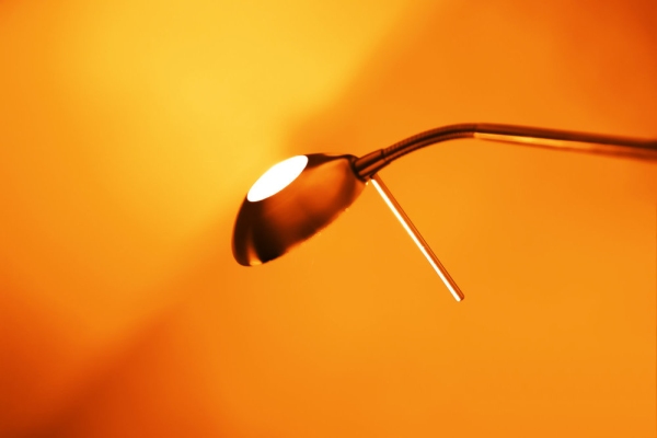 Orange tinted photo of desk lamp