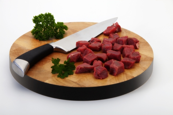 steak and knife on a chopping board.